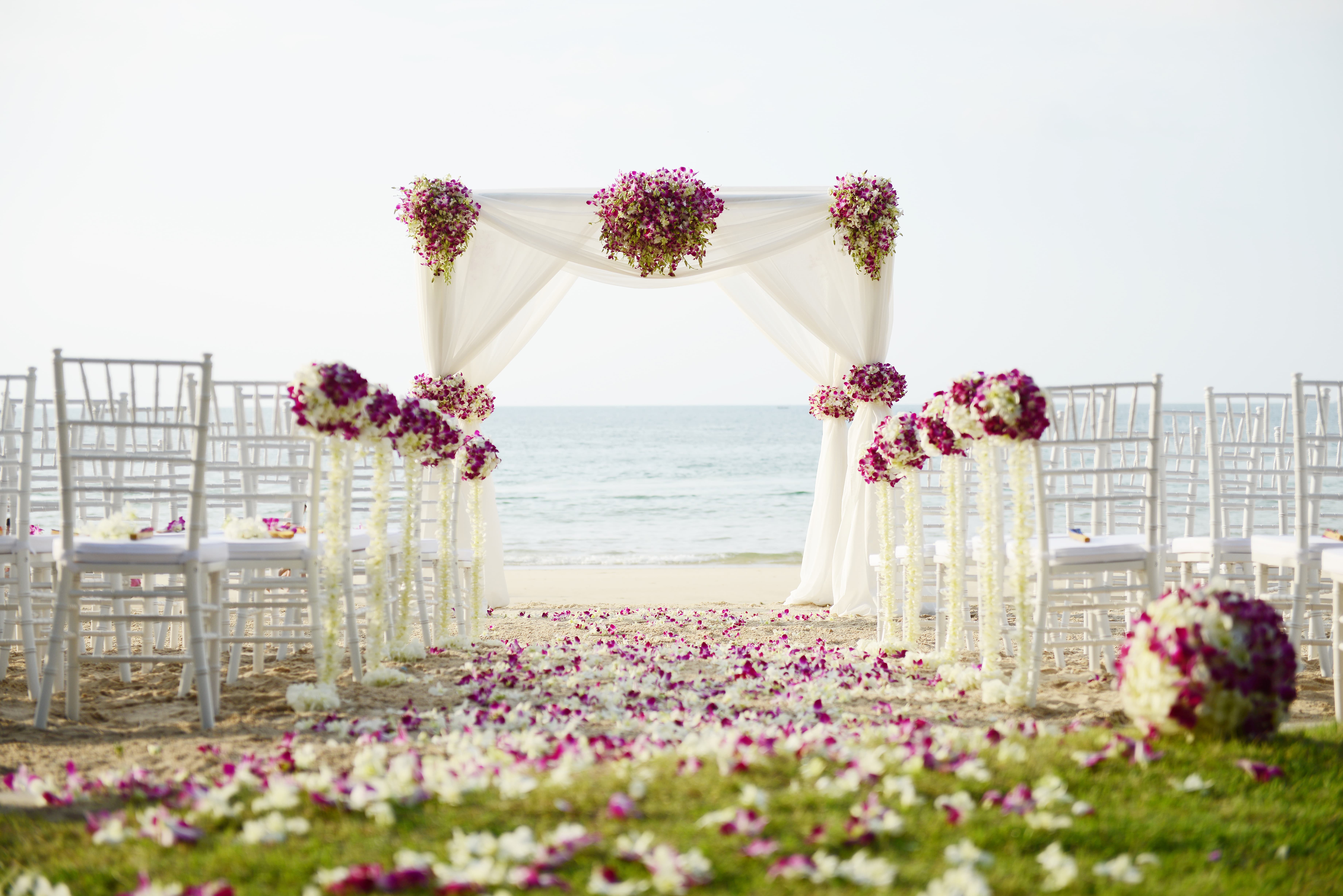 Aufbau einer Hochzeit am Strand mit Blumendekoration
